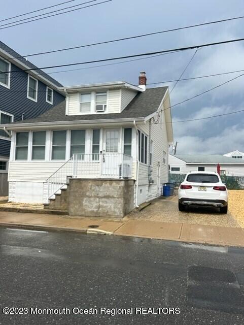 a view of a car parked front of a house