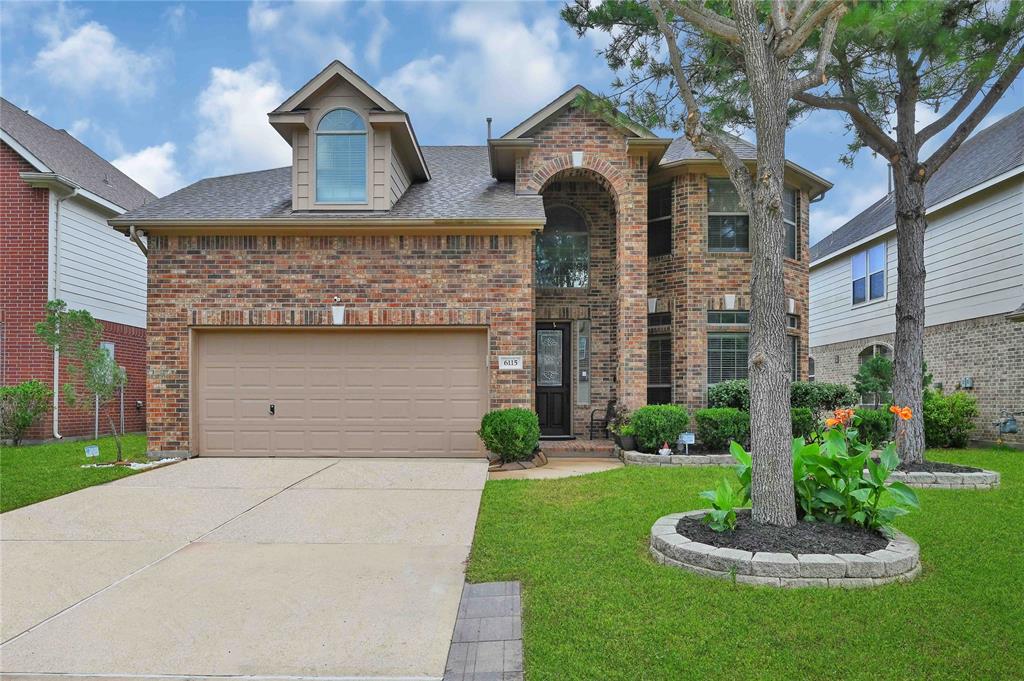 a front view of a house with a yard and garage