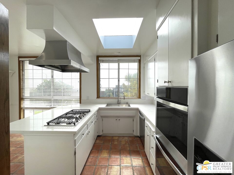 a kitchen with a sink stove and refrigerator