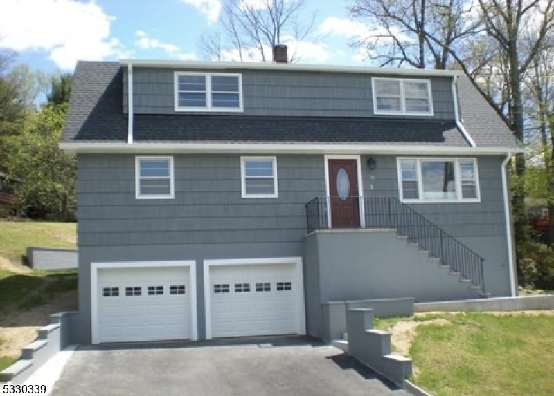 a front view of a house with garage