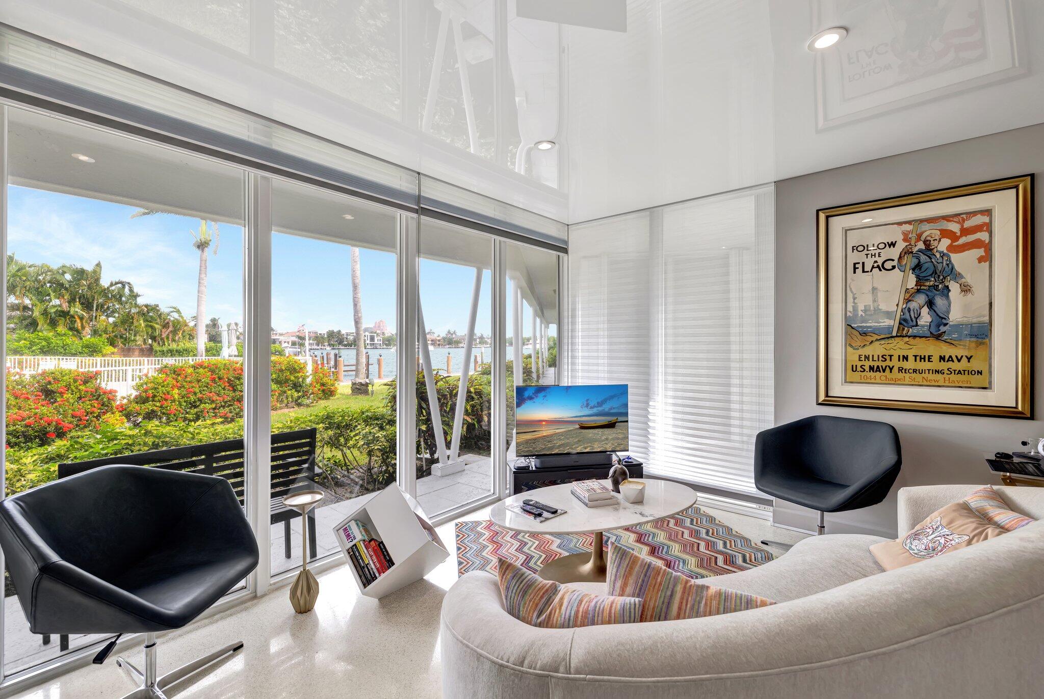 a living room with furniture and a floor to ceiling window