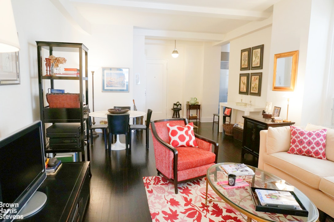 a living room with furniture a rug and a flat screen tv