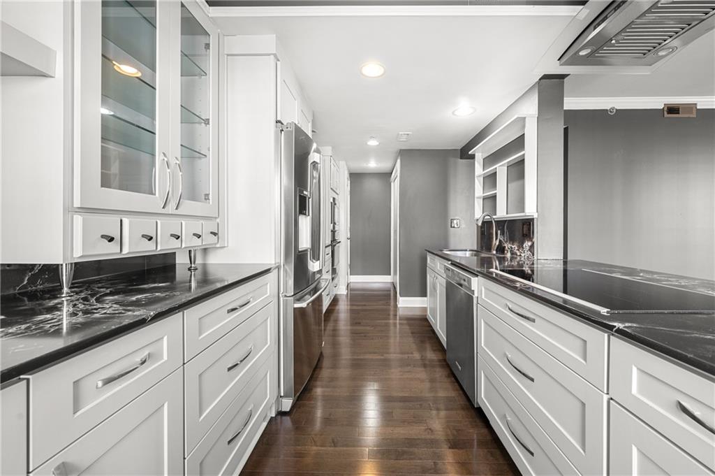 a large kitchen with granite countertop lots of counter space and a sink