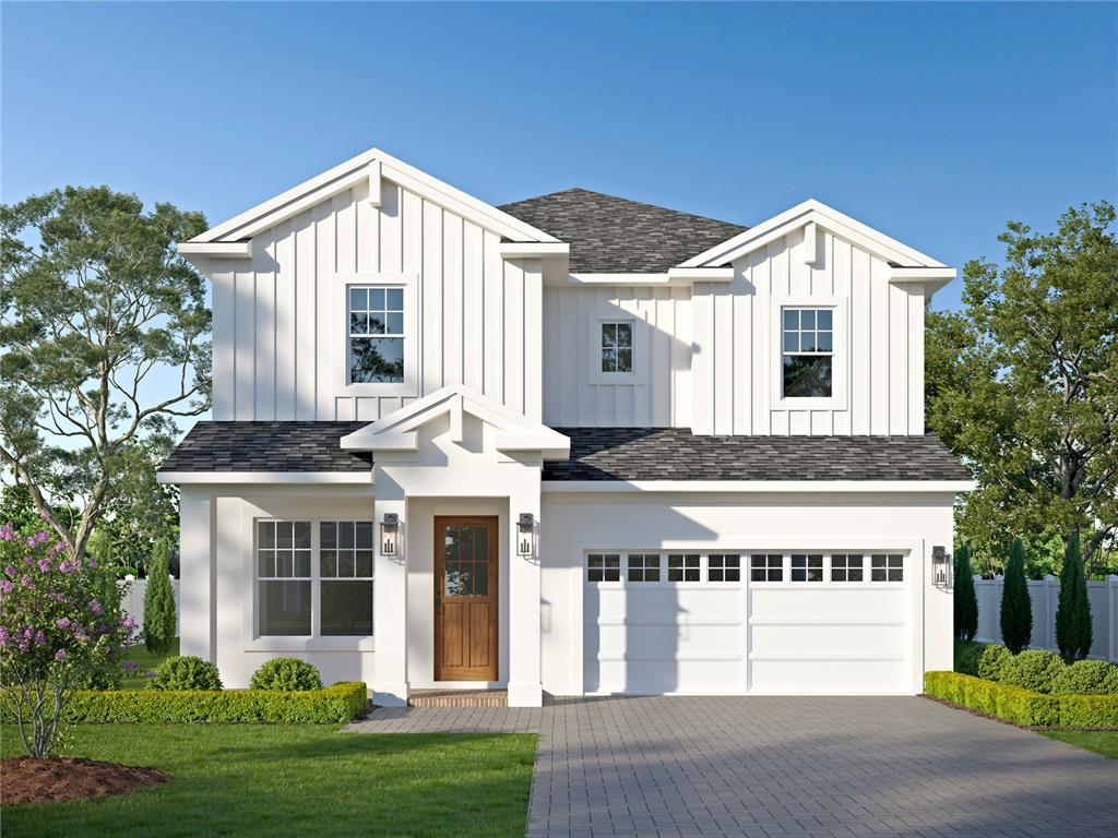 a front view of a house with a yard and trees