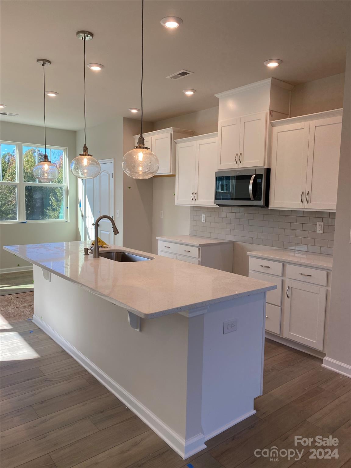 a kitchen with kitchen island a sink stainless steel appliances and cabinets