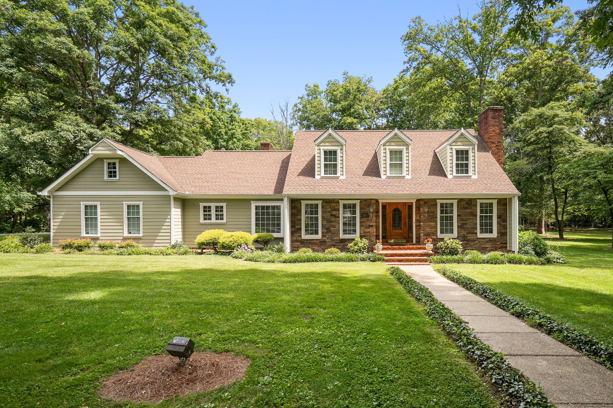 a front view of a house with a garden