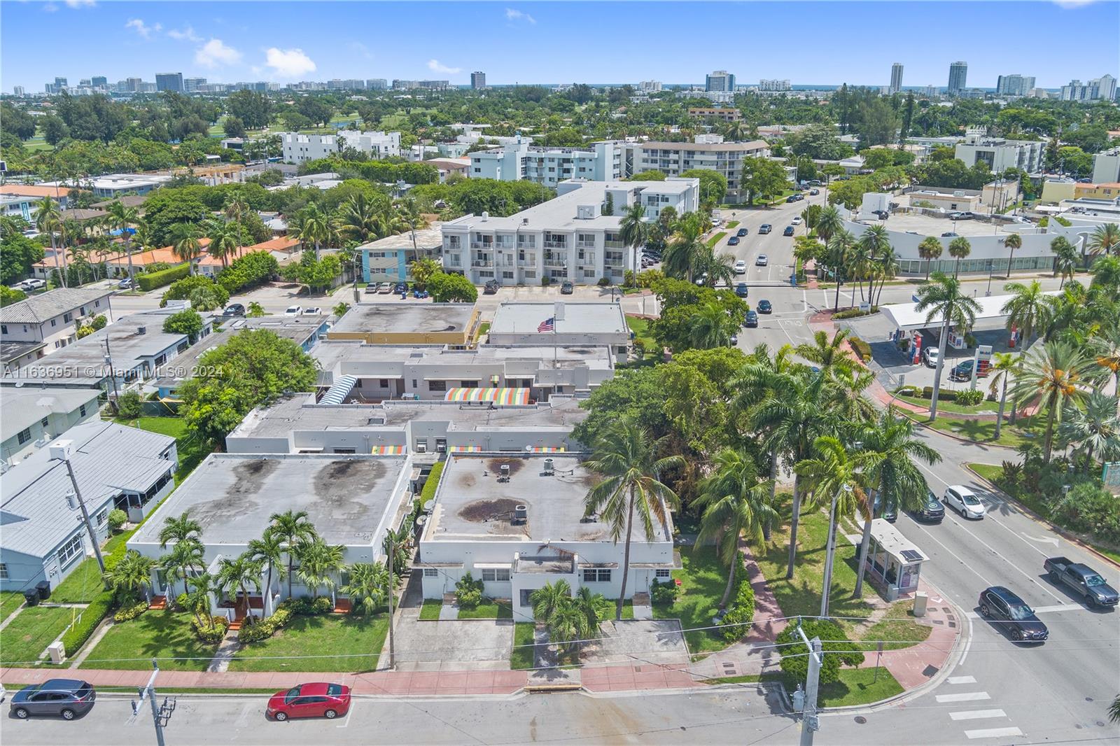 an aerial view of residential houses with outdoor space and street view