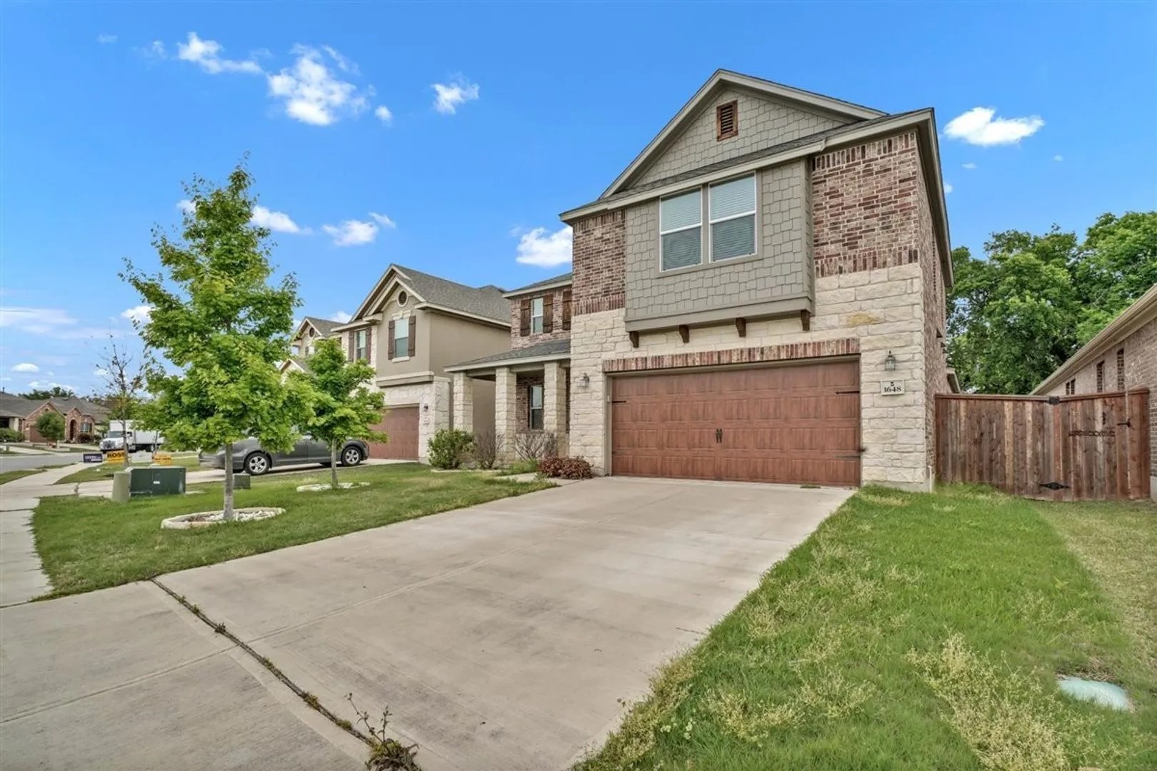 a front view of a house with a yard and garage