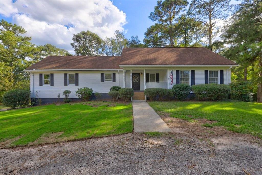 a front view of house with yard and green space