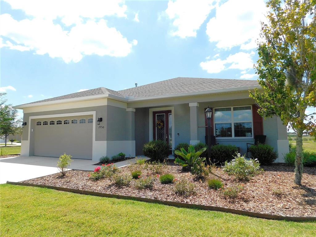 a front view of house with yard and outdoor seating