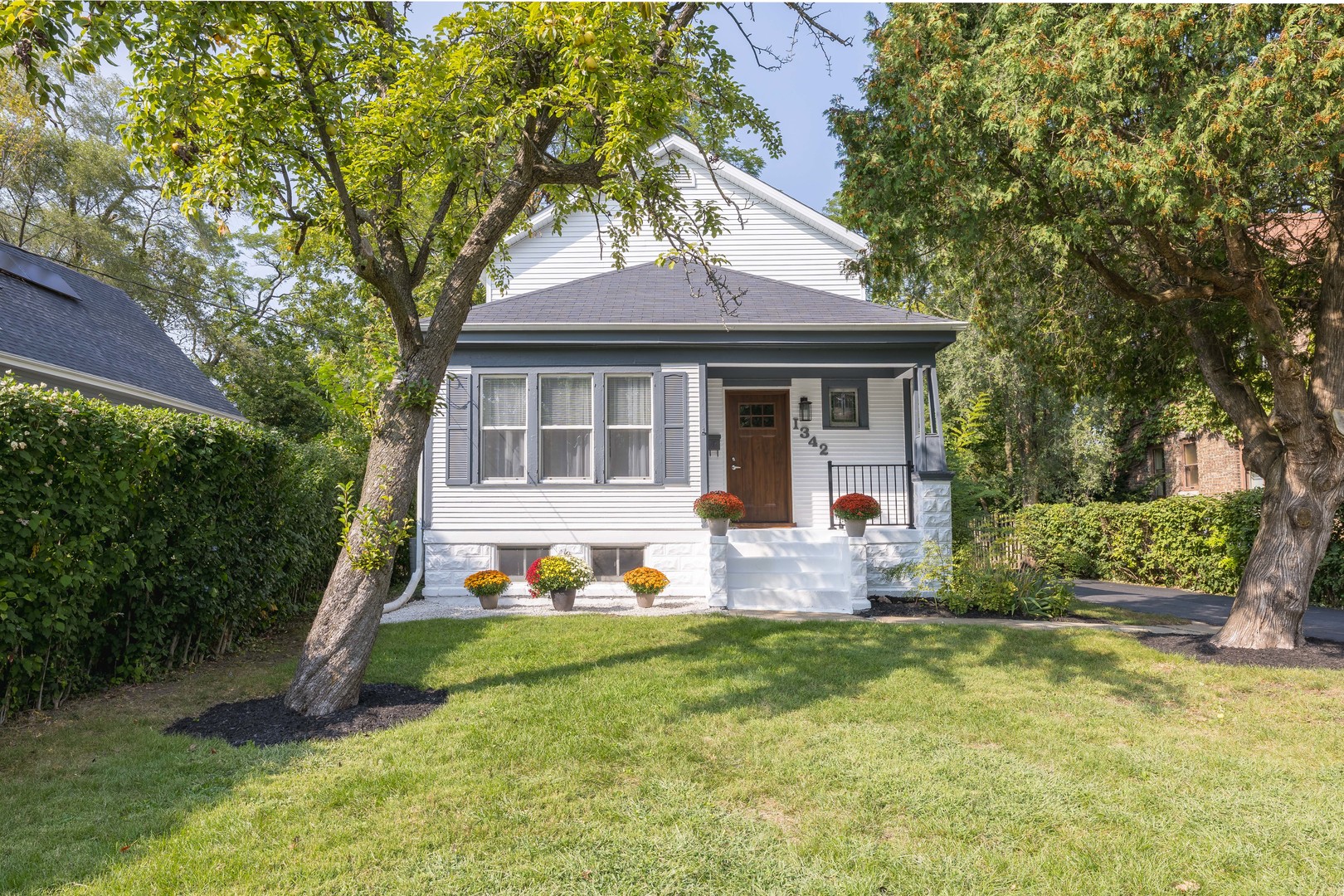 a front view of house with yard and green space