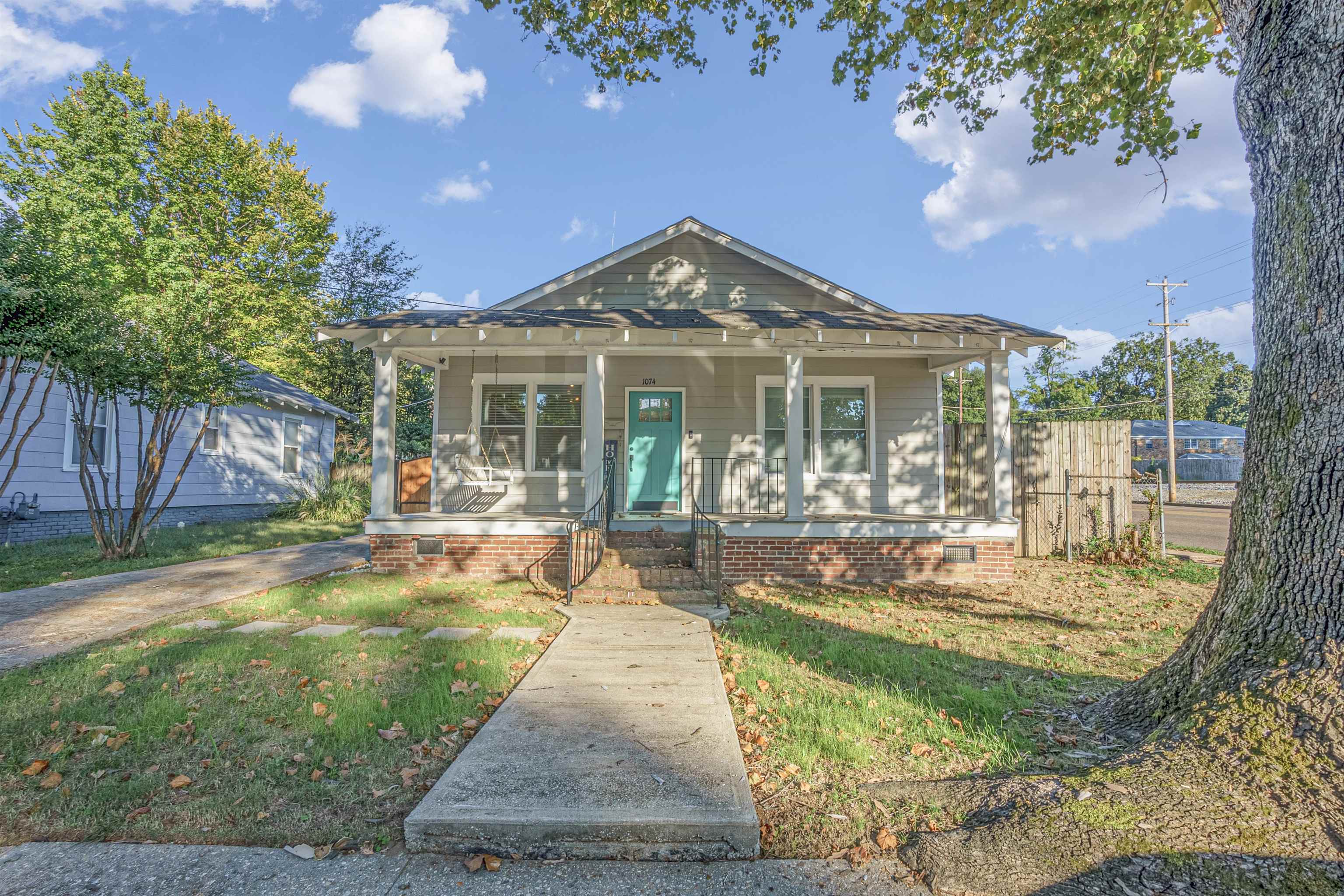 a view of a house with backyard porch and sitting area