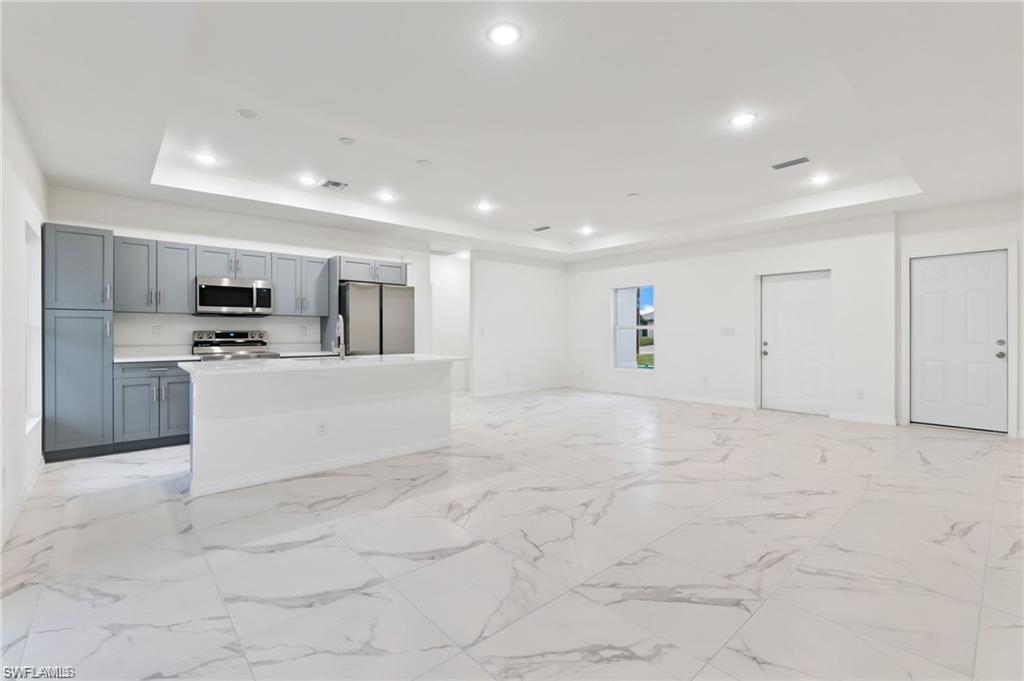 a view of kitchen with microwave and cabinets