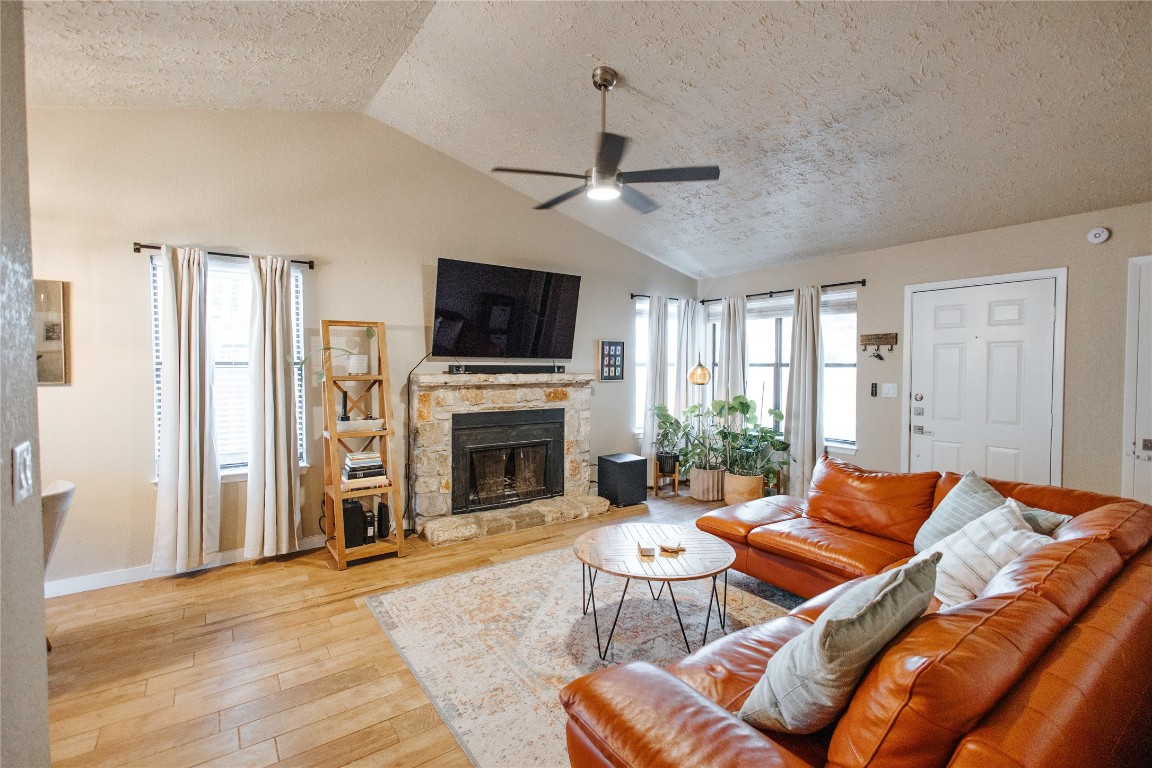 a living room with furniture a fireplace and a flat screen tv