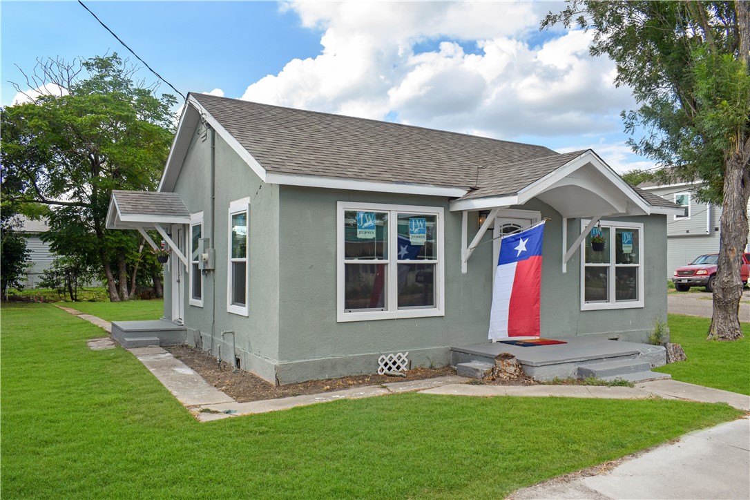 a front view of house with yard and green space