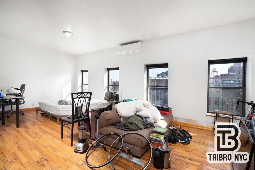 a bedroom with furniture and a window