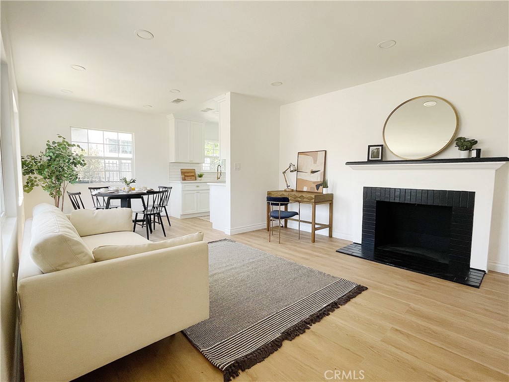 a living room with furniture a window and a fireplace