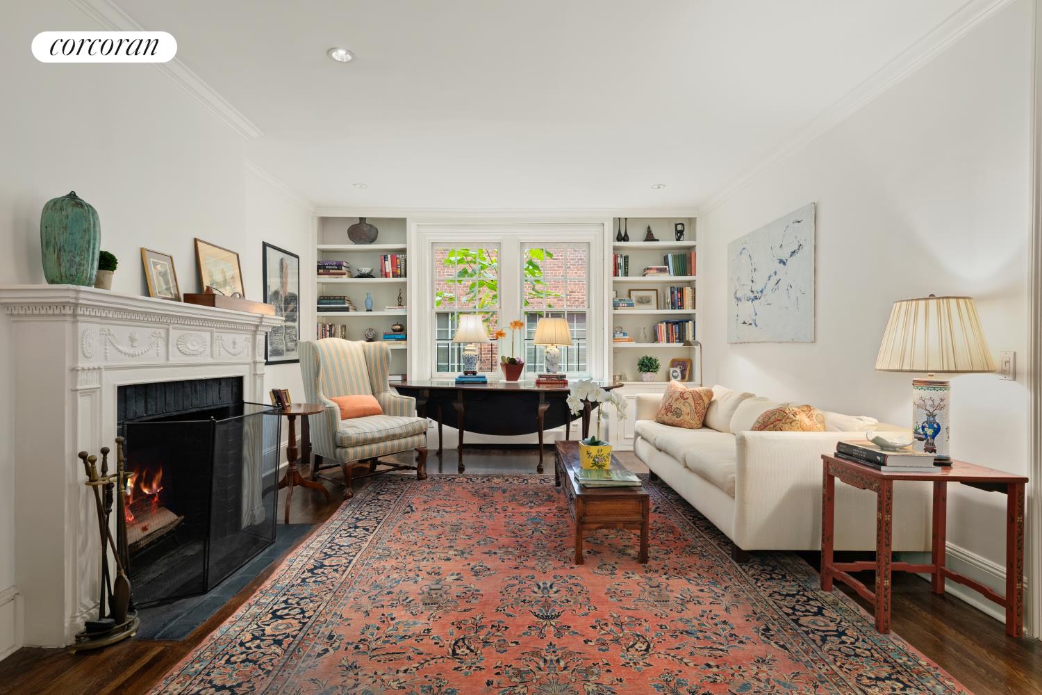 a living room with furniture fireplace and rug