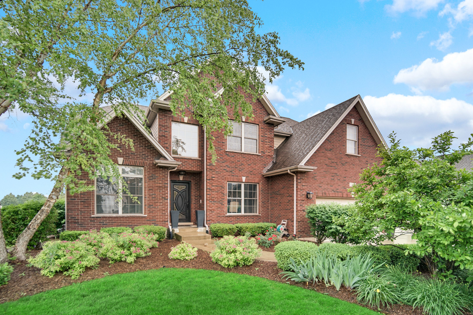 front view of a house with a yard