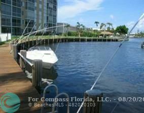 a view of a lake with couches in front of house