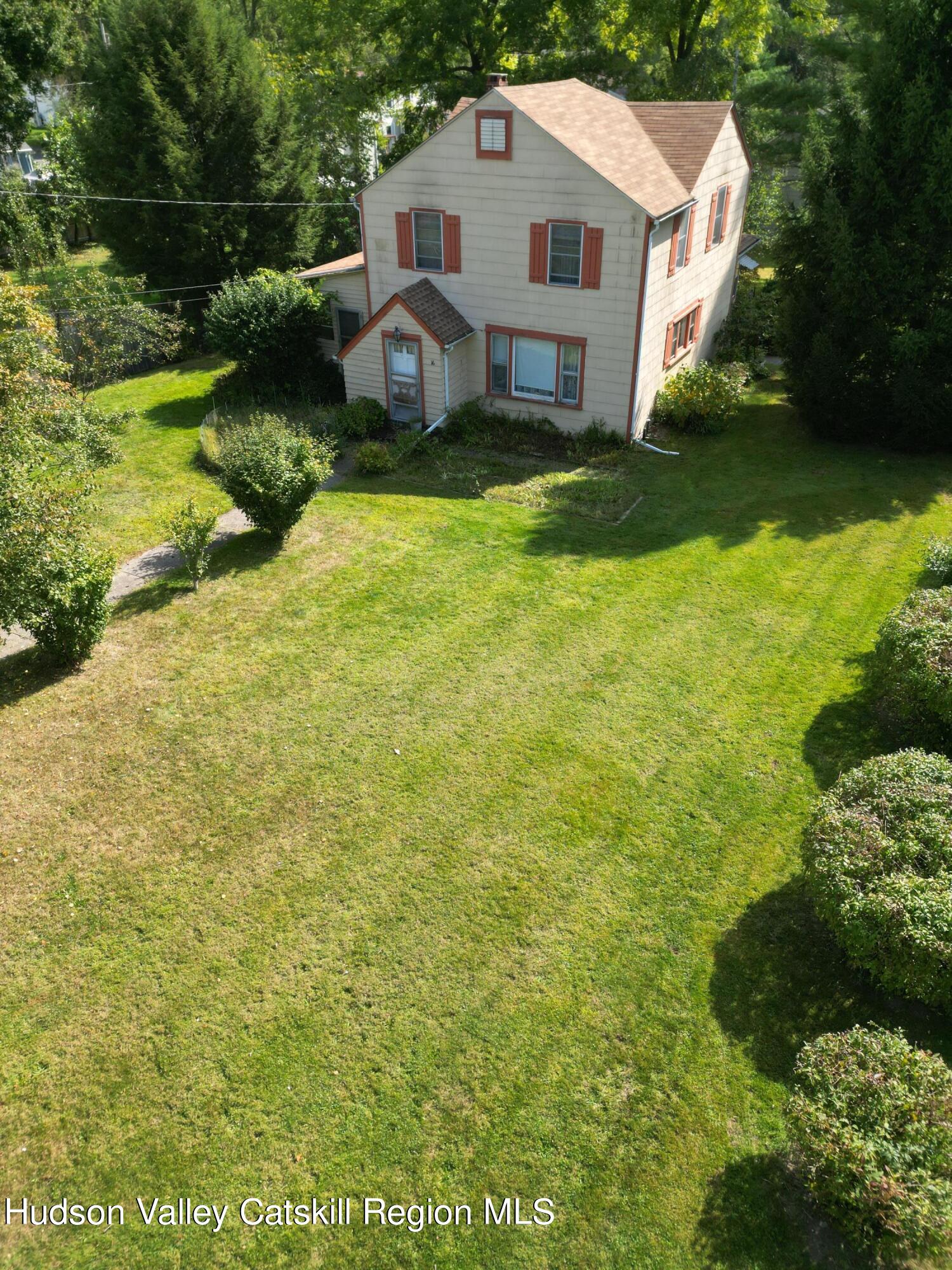 a front view of house with yard and green space