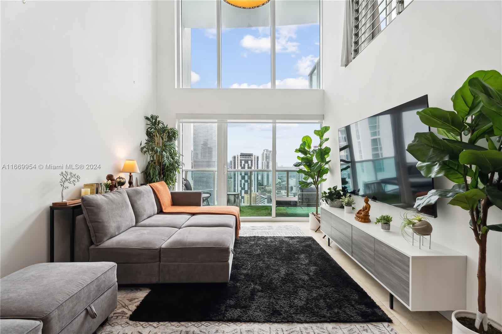 a living room with furniture flowerpot and a potted plant