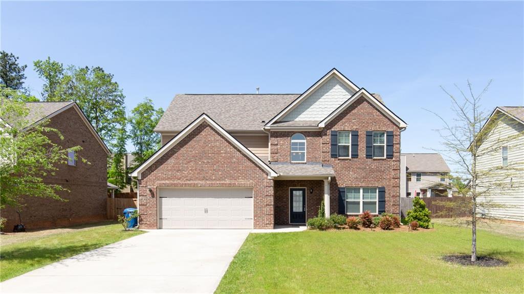 a front view of a house with a yard