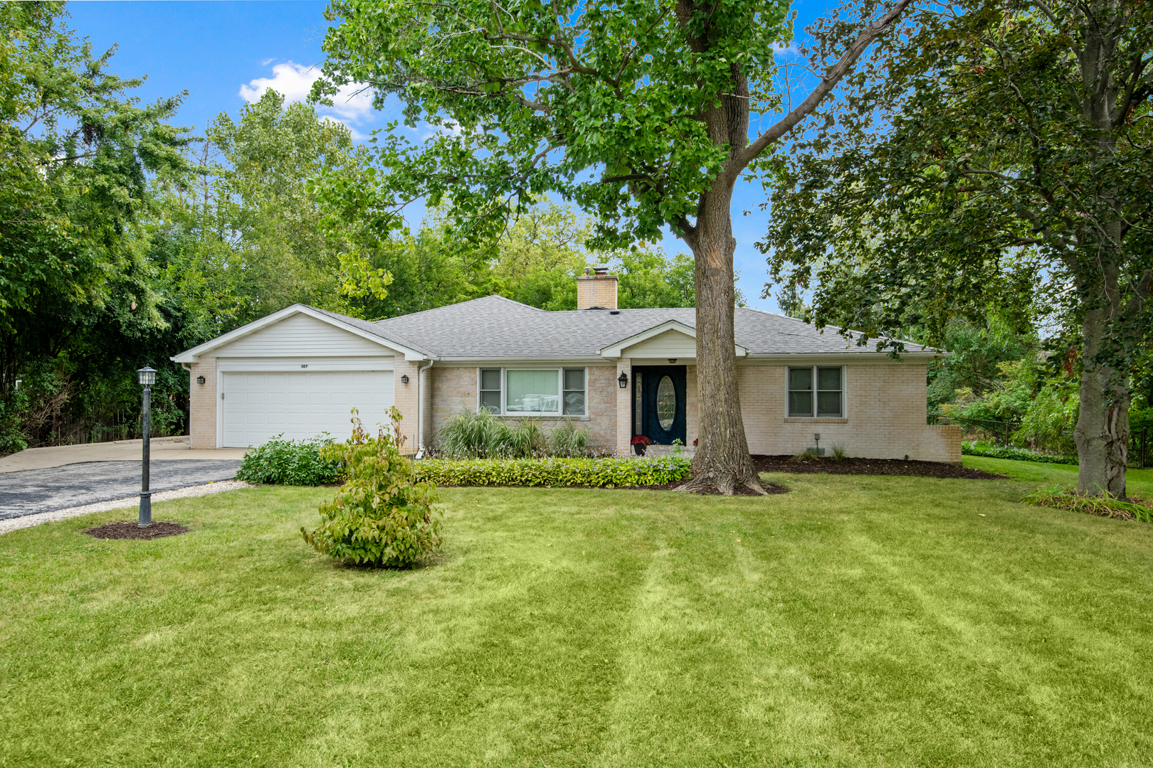 a front view of a house with a yard and garage