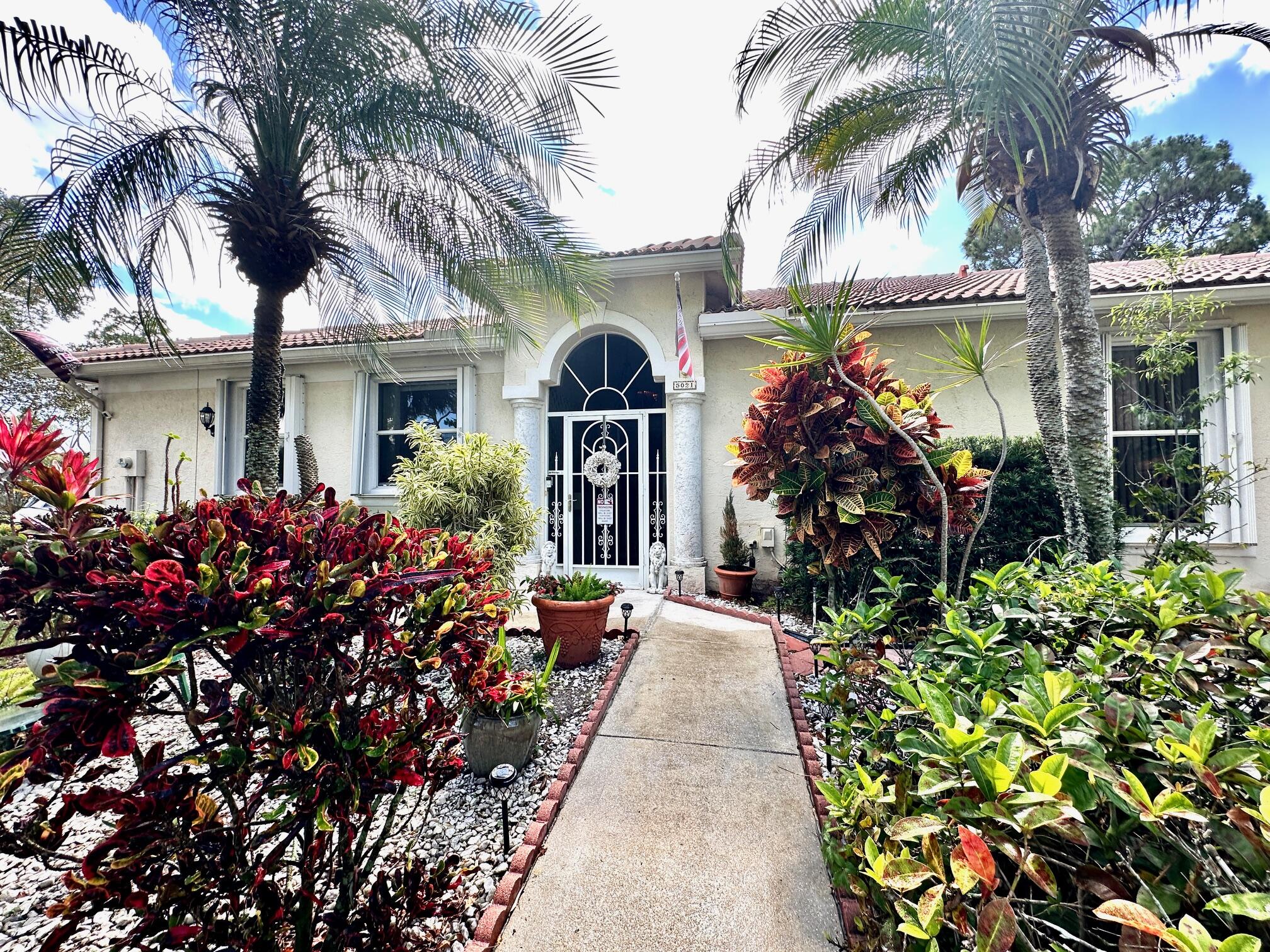 front view of a house with a fountain back yard