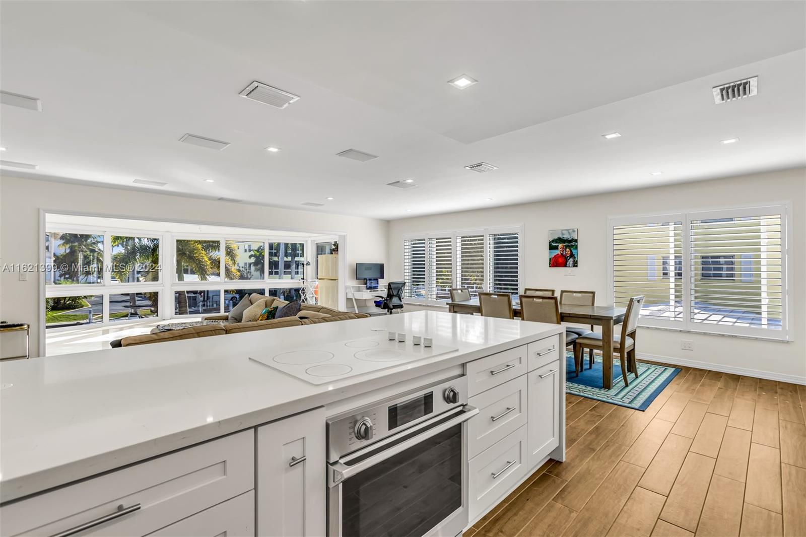 a view of a kitchen with a large counter space appliances and wooden floor