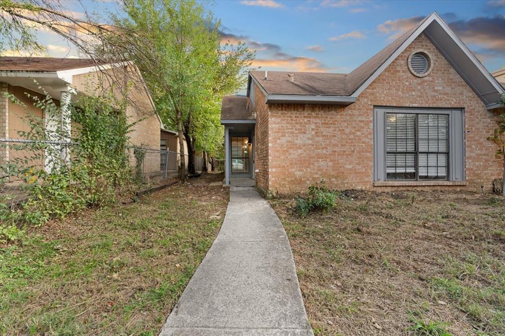 a pathway of a house with a yard