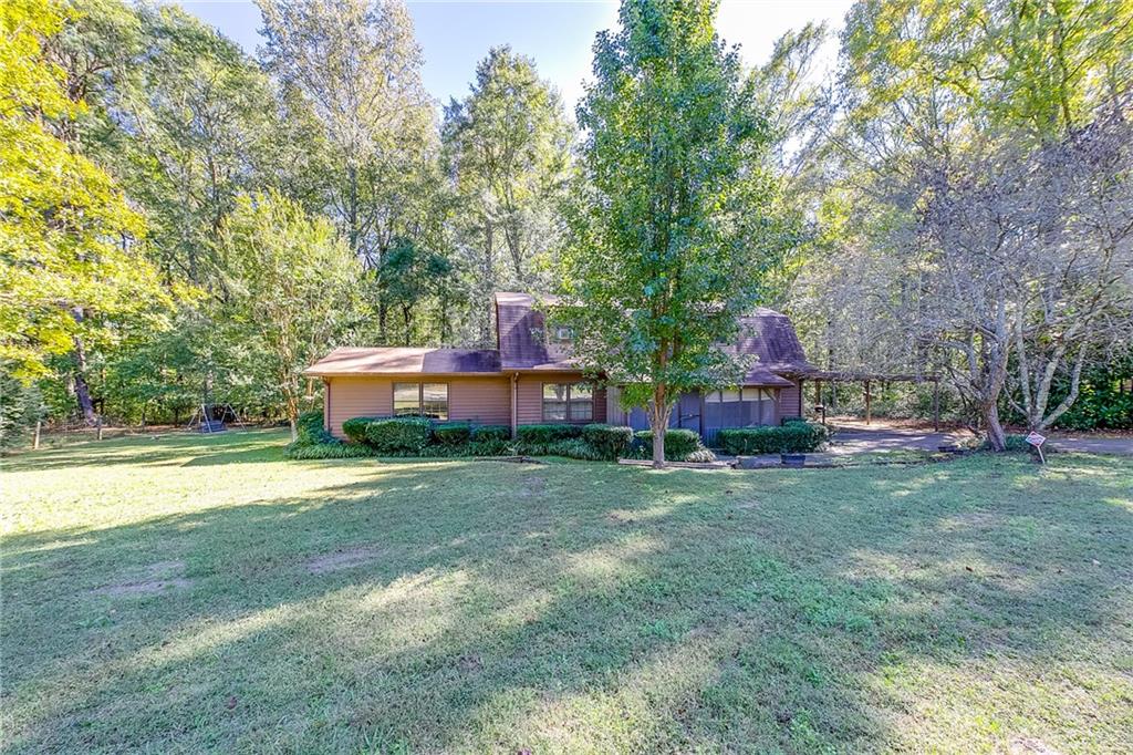 a couple of of a house with a big yard and large trees