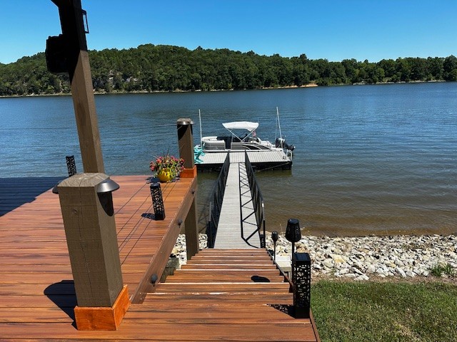 a view of a lake with couches chairs