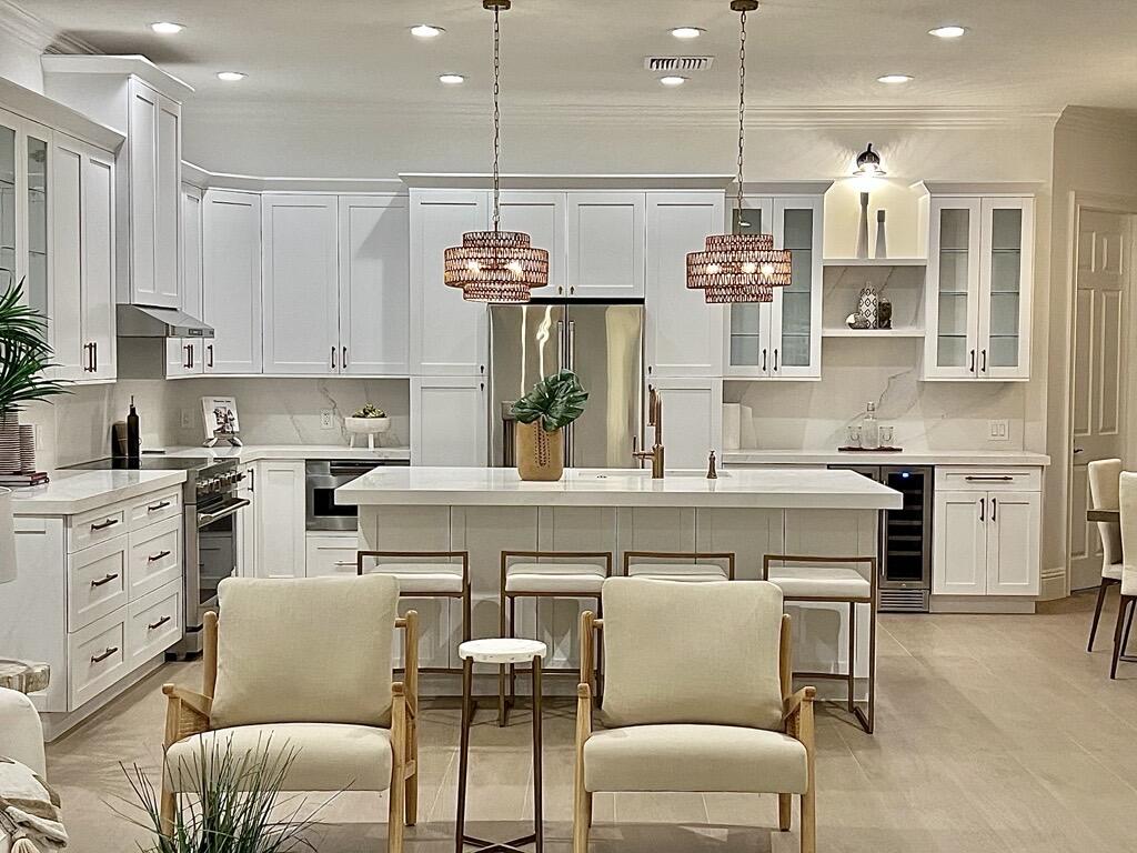 a kitchen with cabinets and chairs