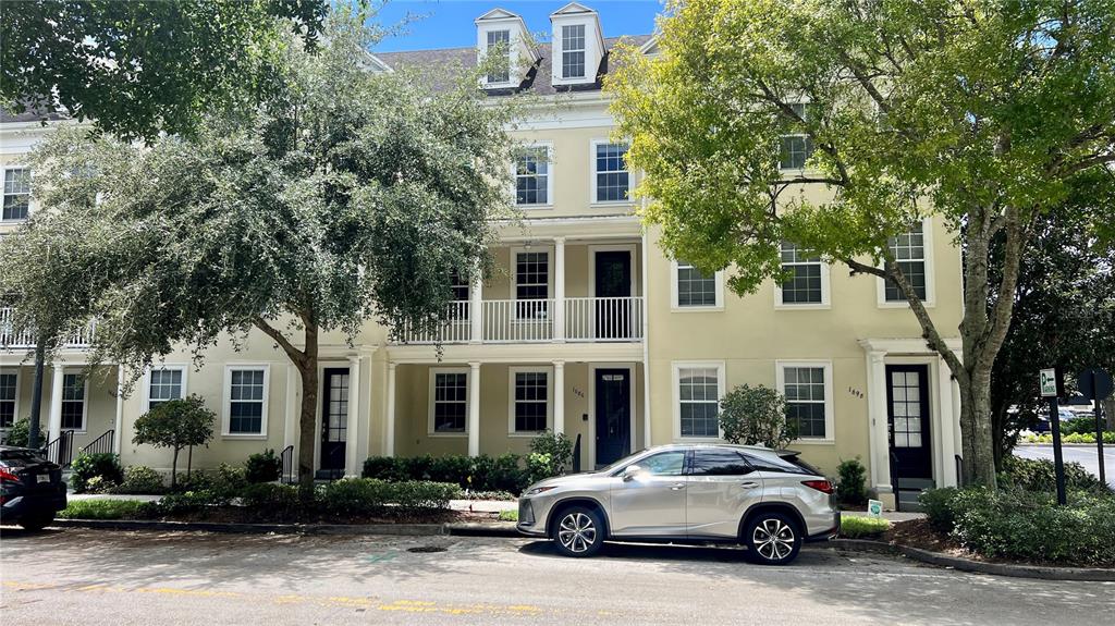 a car parked in front of a white building