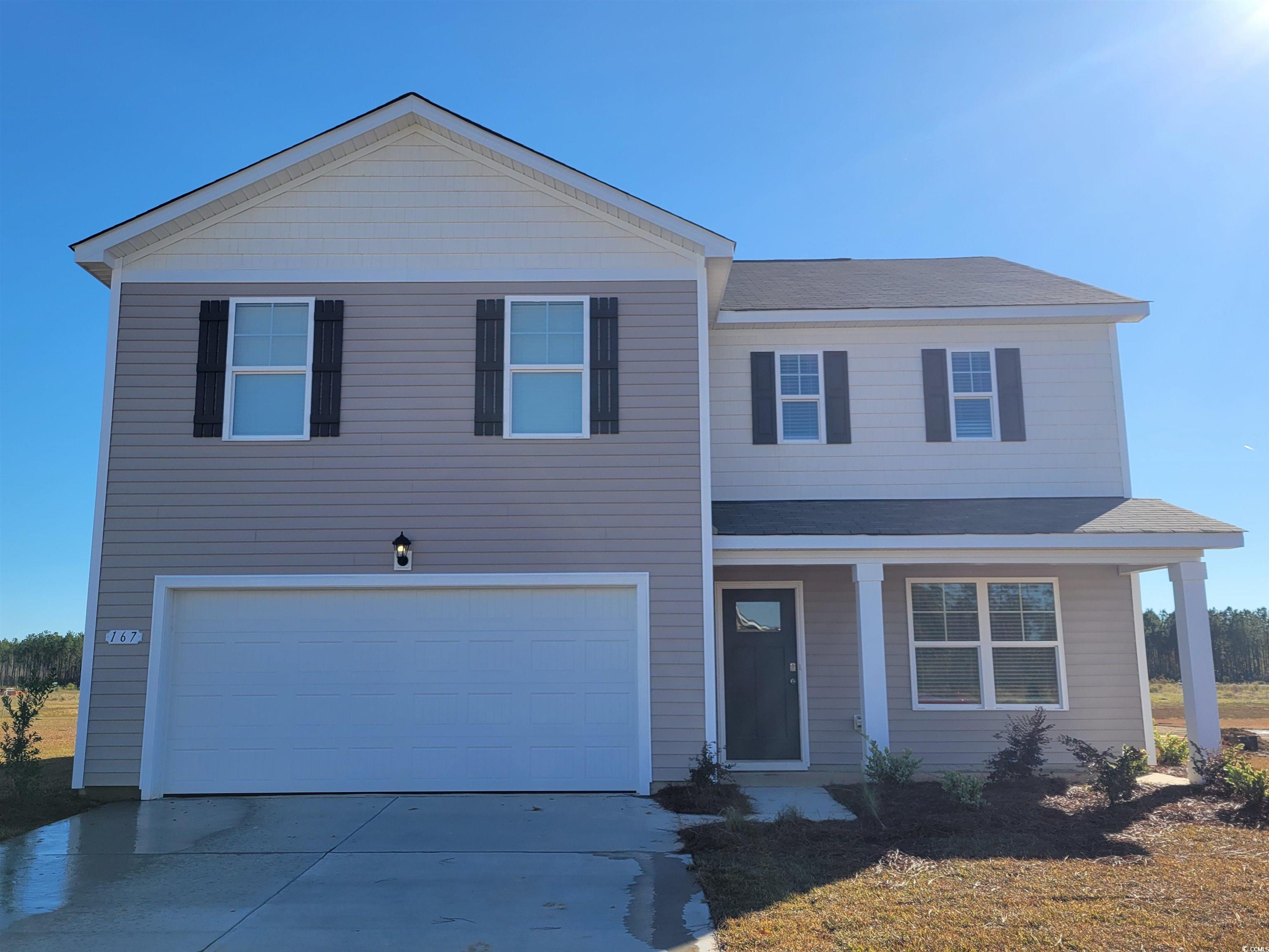 View of front of property with a garage