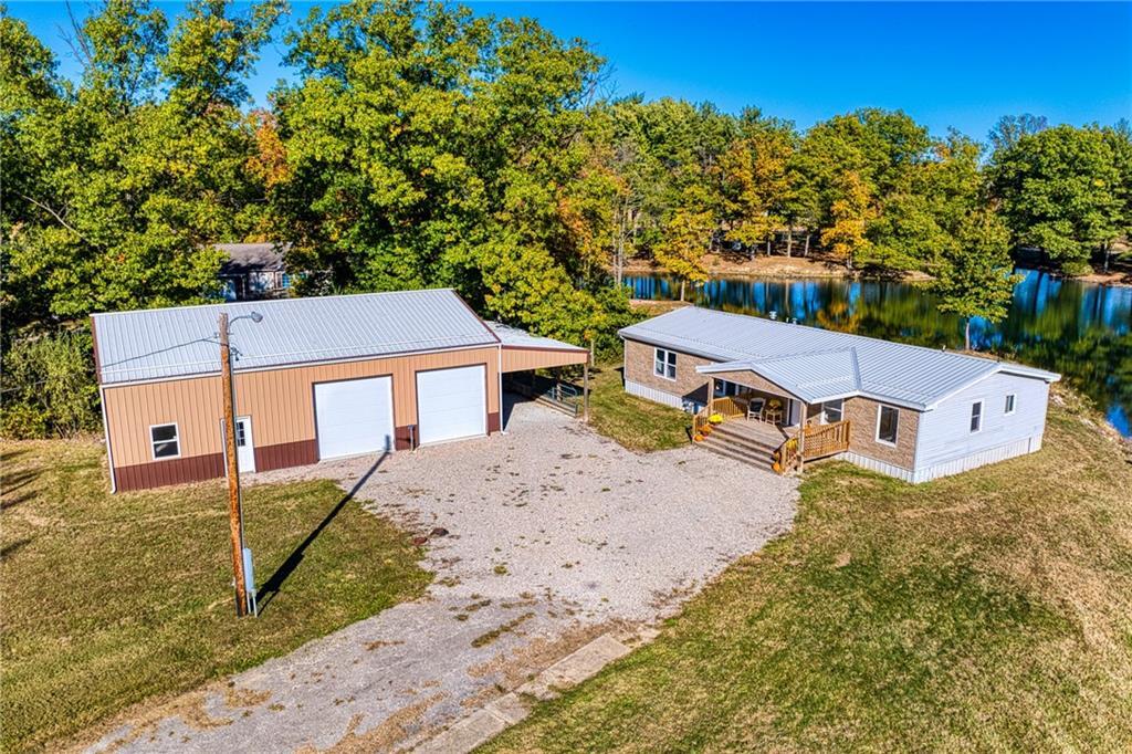 aerial view of a house with a yard and trees