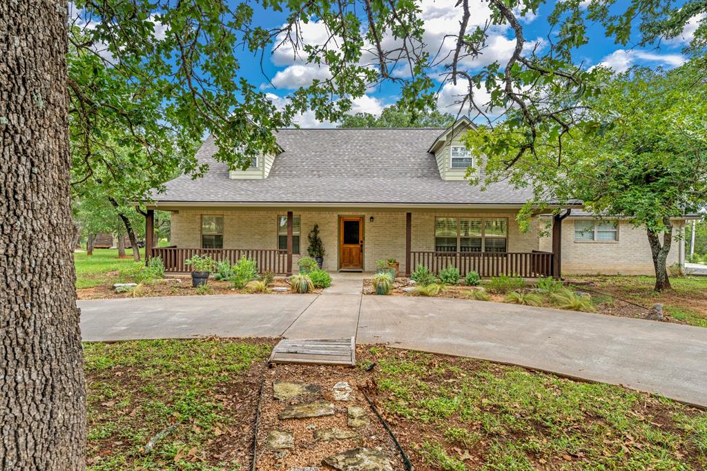 a front view of a house with garden and porch