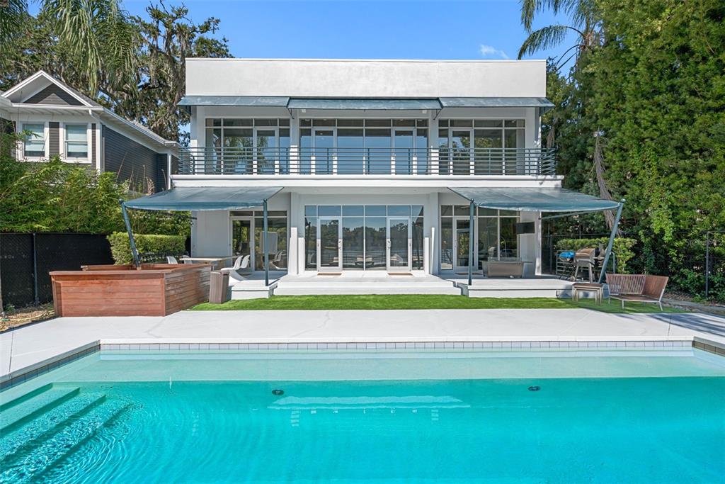 a view of a house with a yard patio and swimming pool