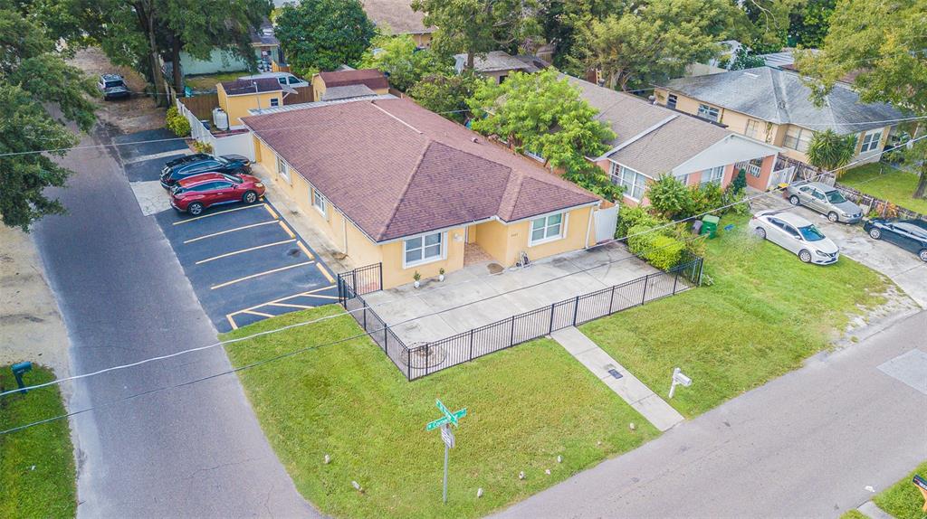 an aerial view of a house with garden space and street view