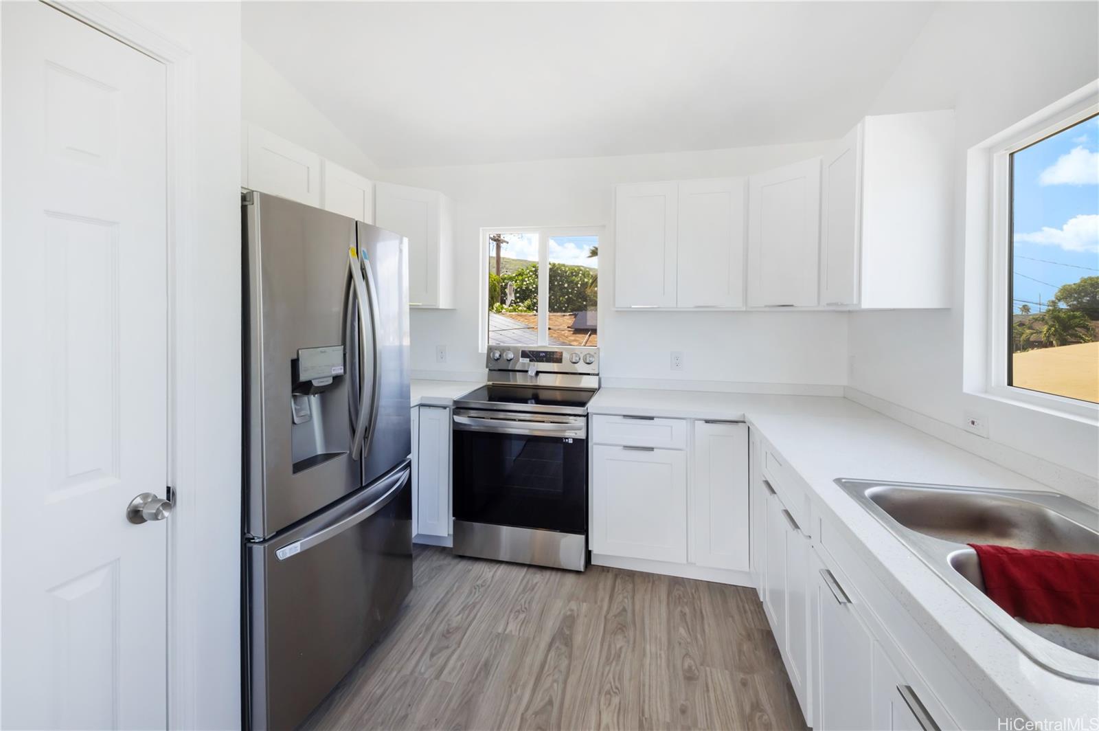 a kitchen with a refrigerator stove and sink