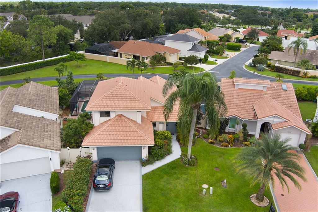 an aerial view of a house with garden space and lake view