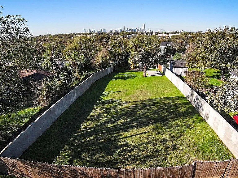 a view of a swimming pool with a yard