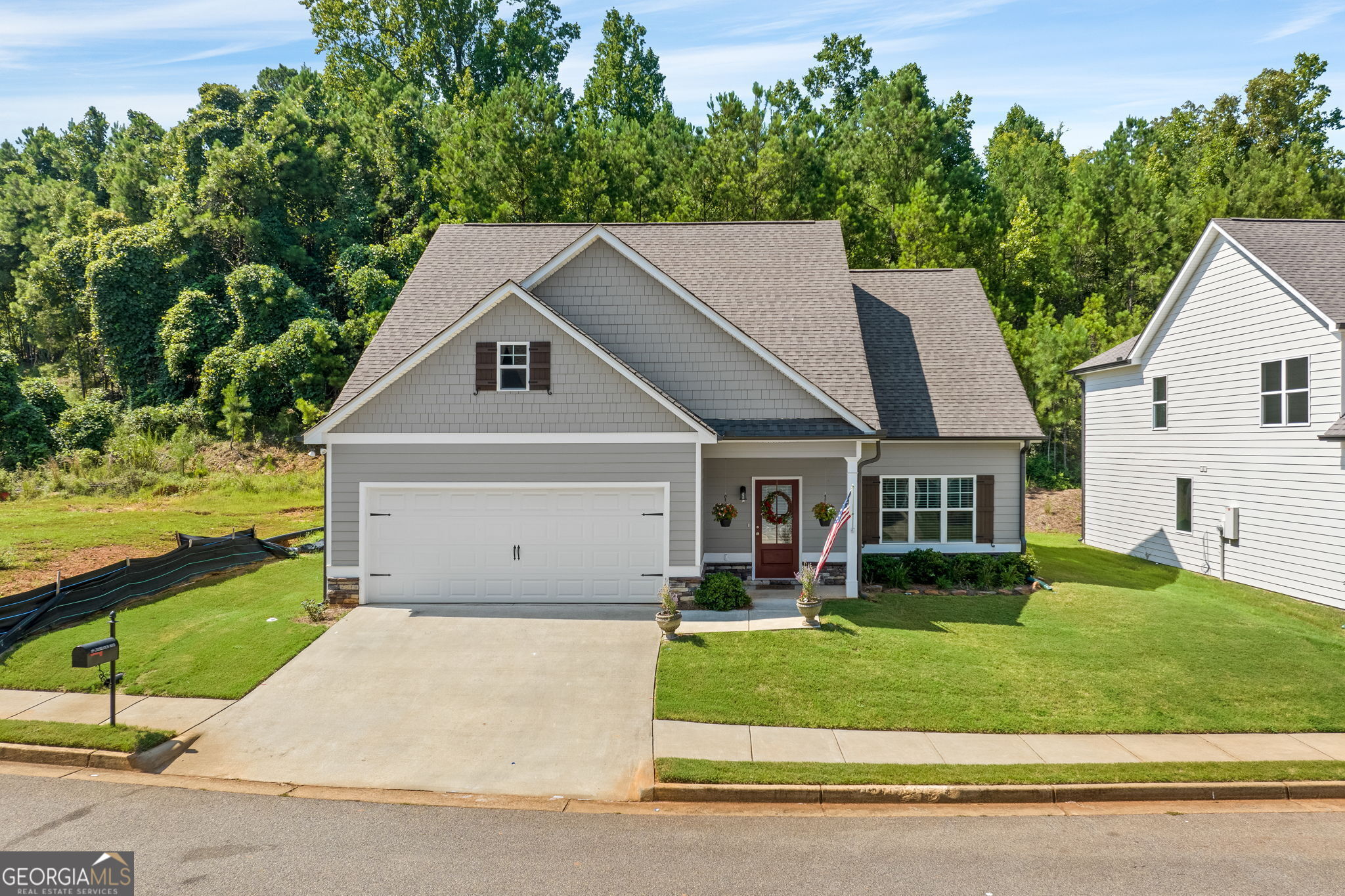 a front view of house with yard and green space