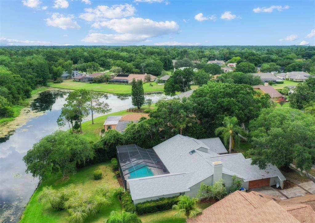 an aerial view of a house with yard swimming pool and outdoor seating