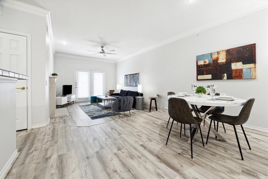 a living room with furniture a flat screen tv and kitchen view