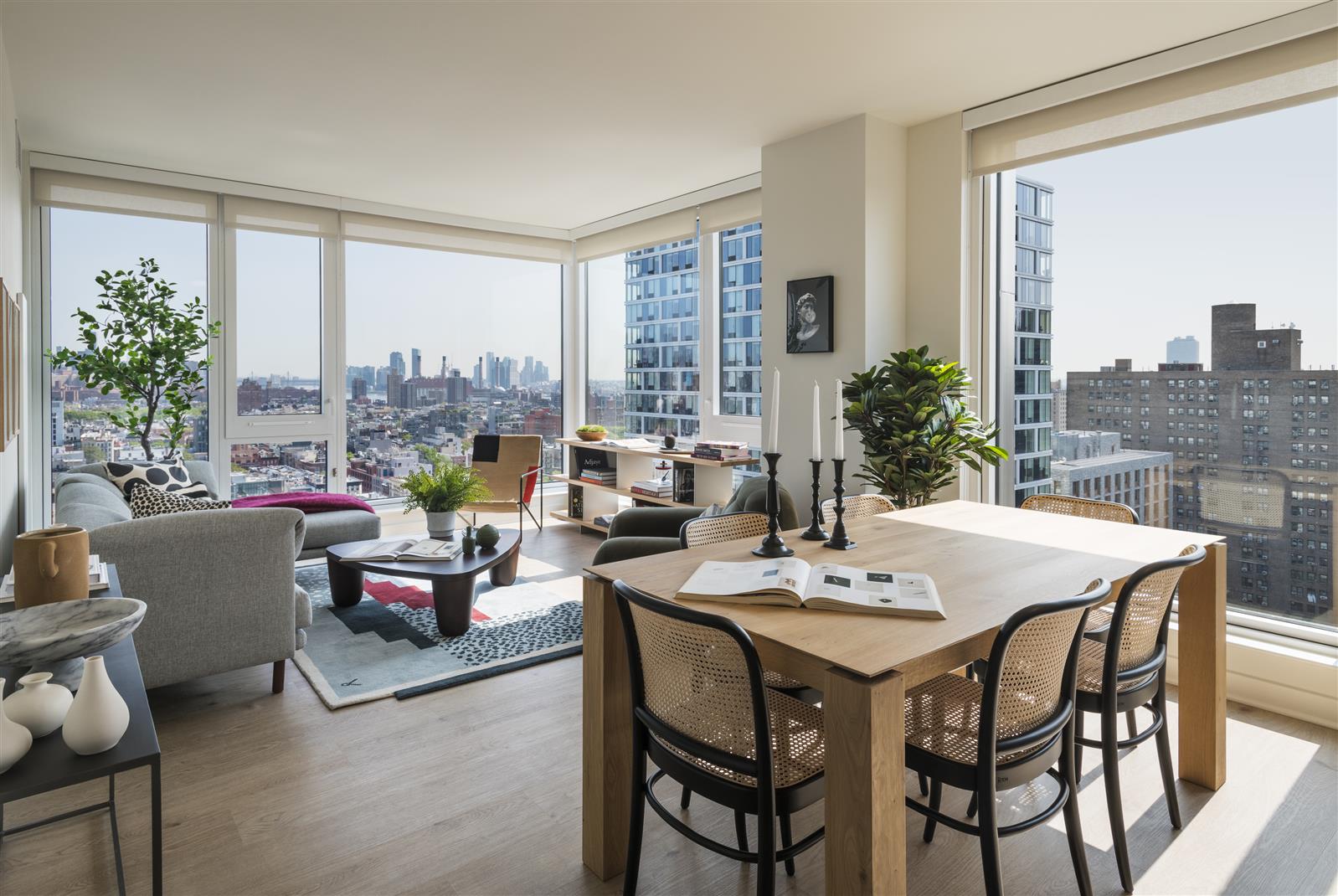 a dining room with furniture and a large window