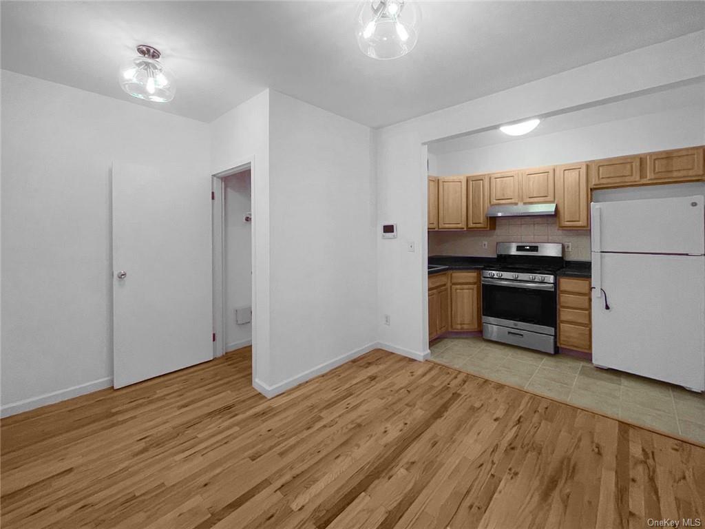 a kitchen with a refrigerator and a stove top oven