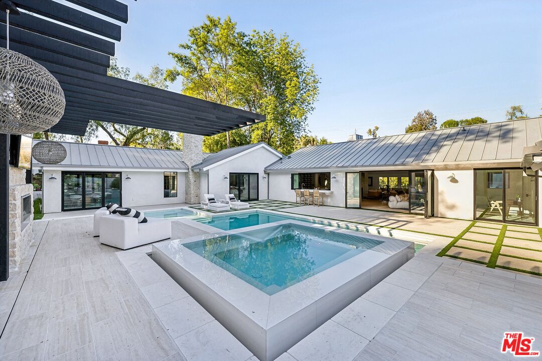 a view of house with swimming pool outdoor seating