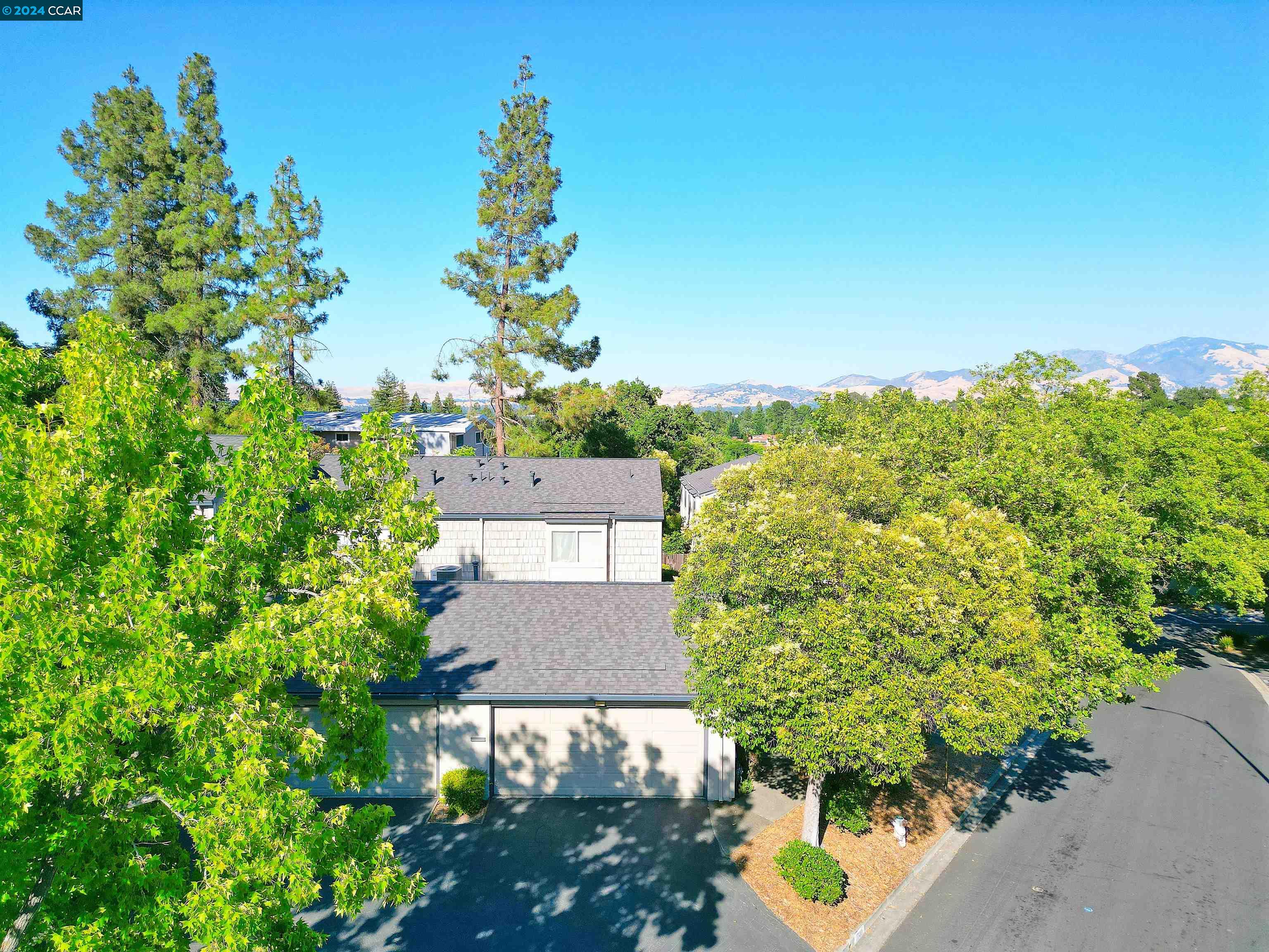 an aerial view of a house with a yard and garden